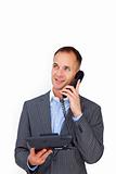 Positive businessman talking on a phone 