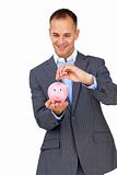 Charismatic businessman saving money in a piggybank 