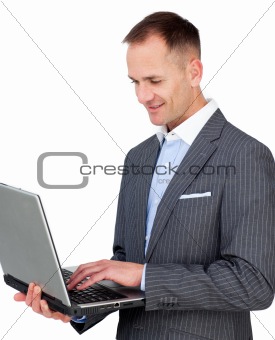 Smiling businessman using a laptop 