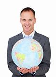 Assertive businessman holding a terreatrial globe 
