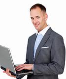 Charismatic businessman using a laptop 