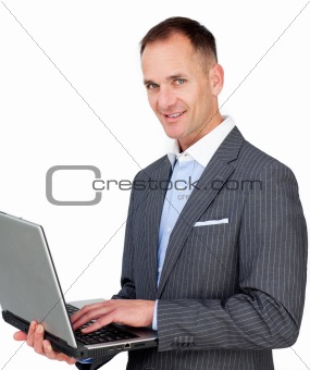 Charismatic businessman using a laptop 
