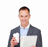 Assertive businessman reading a newspaper