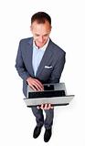 Concentrated businessman using a laptop 