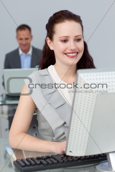 Smiling businesswoman working at a computer in the office the office