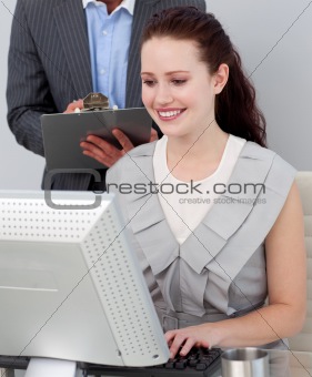 Close-up of a manager checking his employee's work 