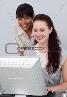 Smiling beautiful businesswoman helping her colleague