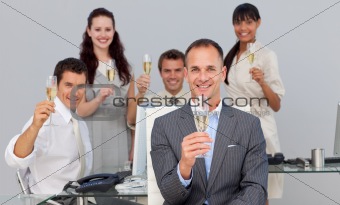 Successful business co-workers toasting with Champagne 
