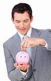 Businessman saving money in a piggy bank