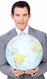 Assertive businessman holding a terrestrial globe 