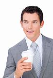 Assertive businessman holding a drinking cup 