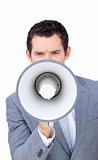 Angry businessman shouting through a megaphone 