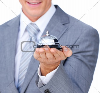 Young attractive waiter holding a hotel bell
