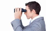 Visionary businessman looking through binoculars 