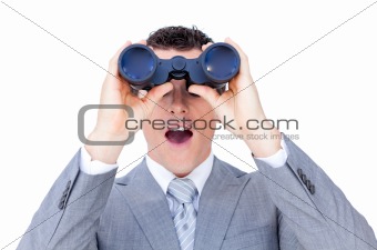 Surprised businessman looking through binoculars 