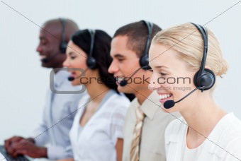 Portrait of smiling business people working in a call center