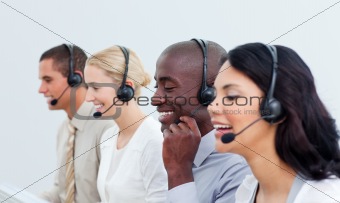 Laughing business people working in a call center