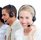 Portraif of a businesswoman and her team working in a call cente