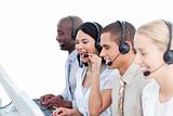Laughing woman and her team working in a call center
