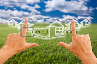 Female Hands Framing Houses Over Grass Field and Sky