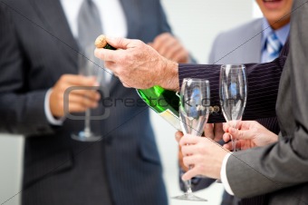 Victorious business team drinking Champagne