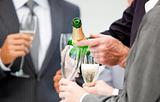 Close-up of a businessman serving Champagne 