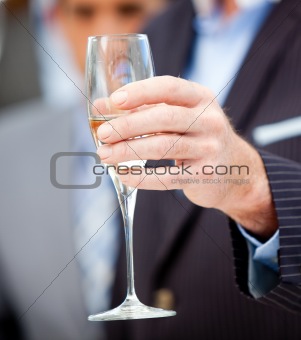Close-up of a businessman holding a glass of Champagne