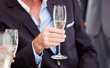 Close-up of a senior businessman holding a glass of Champagne