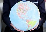 Close-up of a business person holding a terrestrial globe