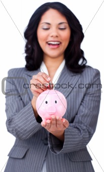 Positive businesswoman saving money in a piggybank 