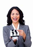 Enthusiastic businesswoman consulting a business card holder 