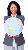 Ethnic businesswoman smiling at global business