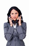 Stressed businesswoman tangled up in phone wires 