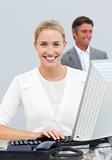 Smiling businesswoman working at her computer