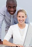 Afro-american businessman and his colleague working at a compute