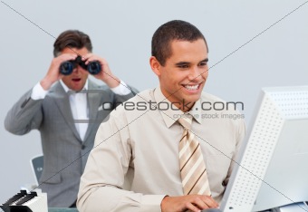 Charimastic businessman looking his colleague's computer through
