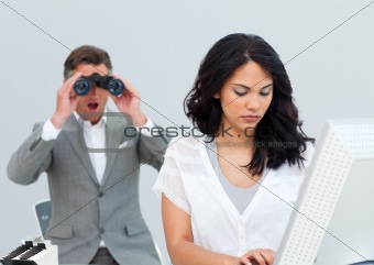 Charismatic businessman looking his colleague's computer through
