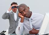 Afro-american businessman annoyed by a man looking through binoc