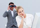 Blond businesswoman annoyed by a man looking through binoculars