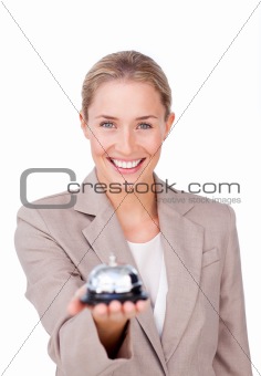 Smiling businesswoman holding a bell