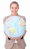 Confident businesswoman holding a terrestrial globe 