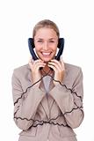 Smiling businesswoman tangled up in phone wires 