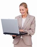 Charismatic businesswoman using a laptop 