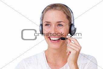 Radiant busineswoman talking on a headset 