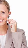 Close-up of a smiling businesswoman using headset 
