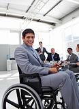 Young businessman in a wheelchair at a meeting 