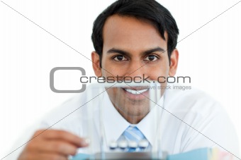 Smiling businessman playing with kinetic balls 
