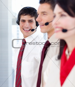 Businessman with headset on smiling at the camera