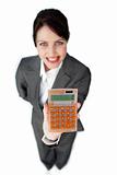 Cheerful businesswoman holding a calculator 