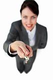 Smiling businesswoman holding a key 